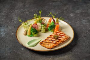 سمك السالمون المشوي | Grilled Salmon مع صلصة كريمة الثوم والليمون تقدم مع الارز و البطاطا المهروسة | With Cream of garlic sauce and lemon served with sauteed vegetables and mashed potatoes